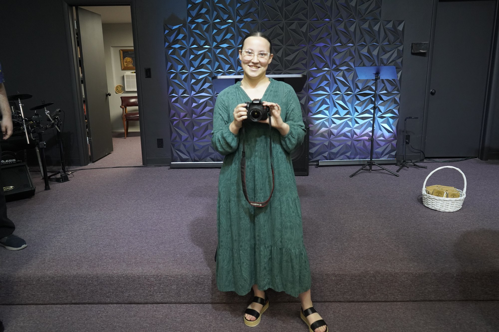 Sakora Crank holding her camera at Refuge Church